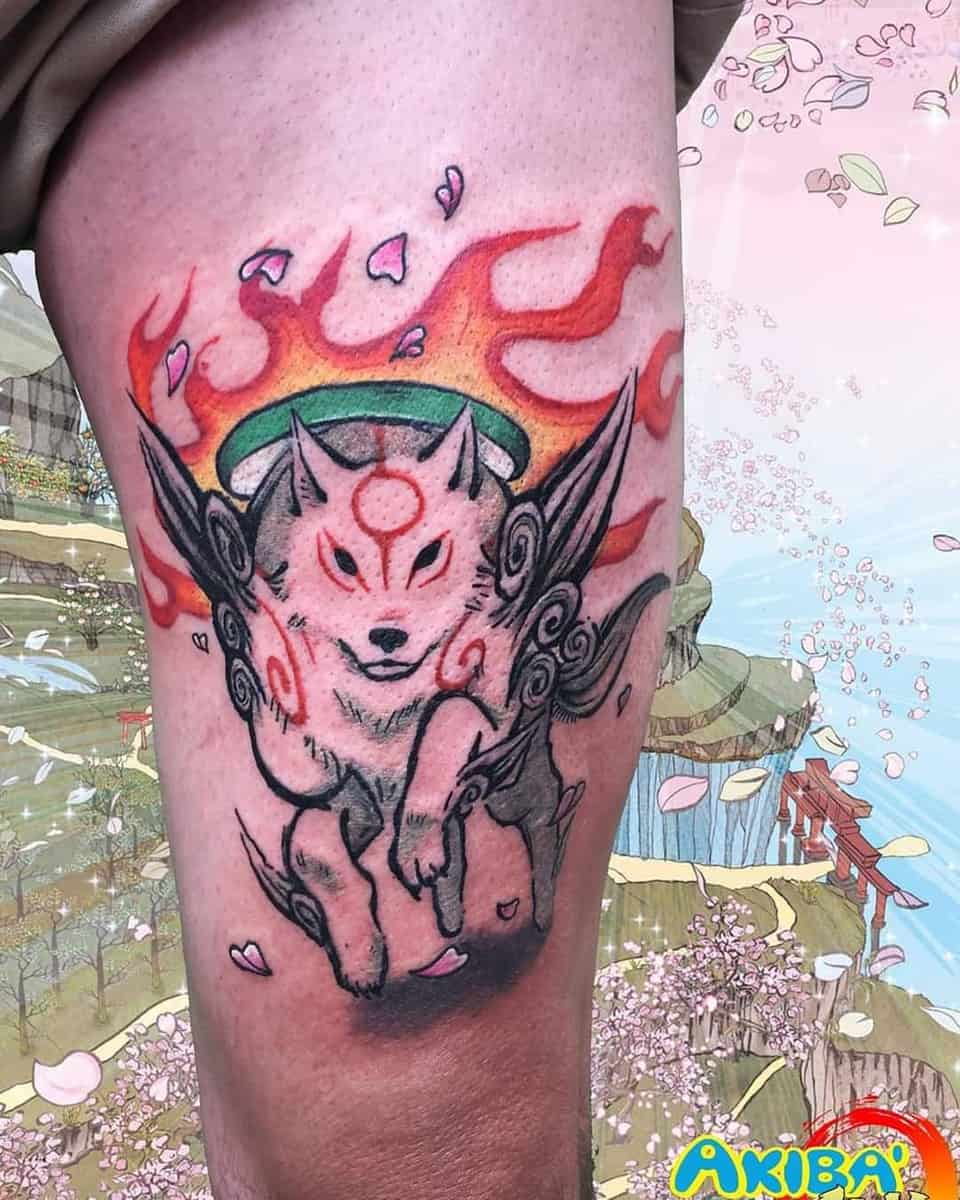 Vibrant tattoo of Moro from Princess Mononoke with flames and cherry blossom petals on the thigh