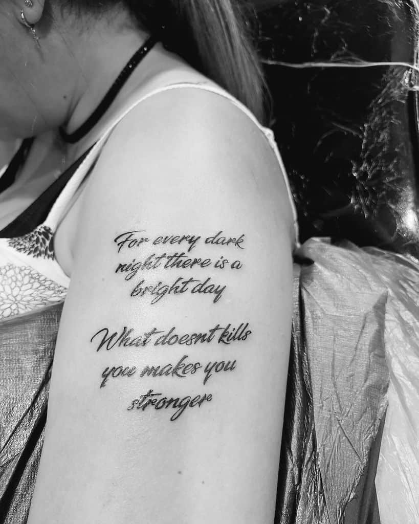 Woman's upper arm with tattoo: "For every dark night there is a bright day. What doesn't kill you makes you stronger"