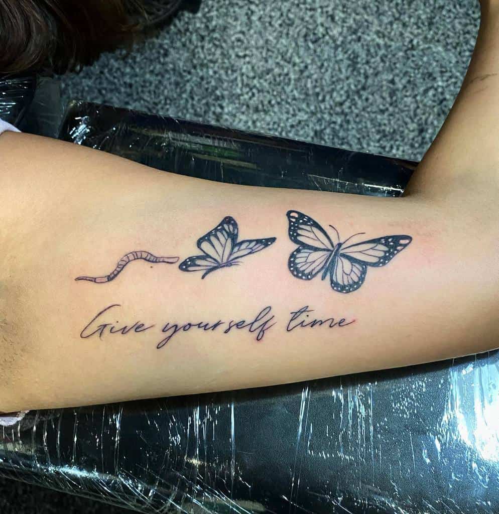 Tattoo of a caterpillar transforming into butterflies with text, "Give yourself time" on an arm