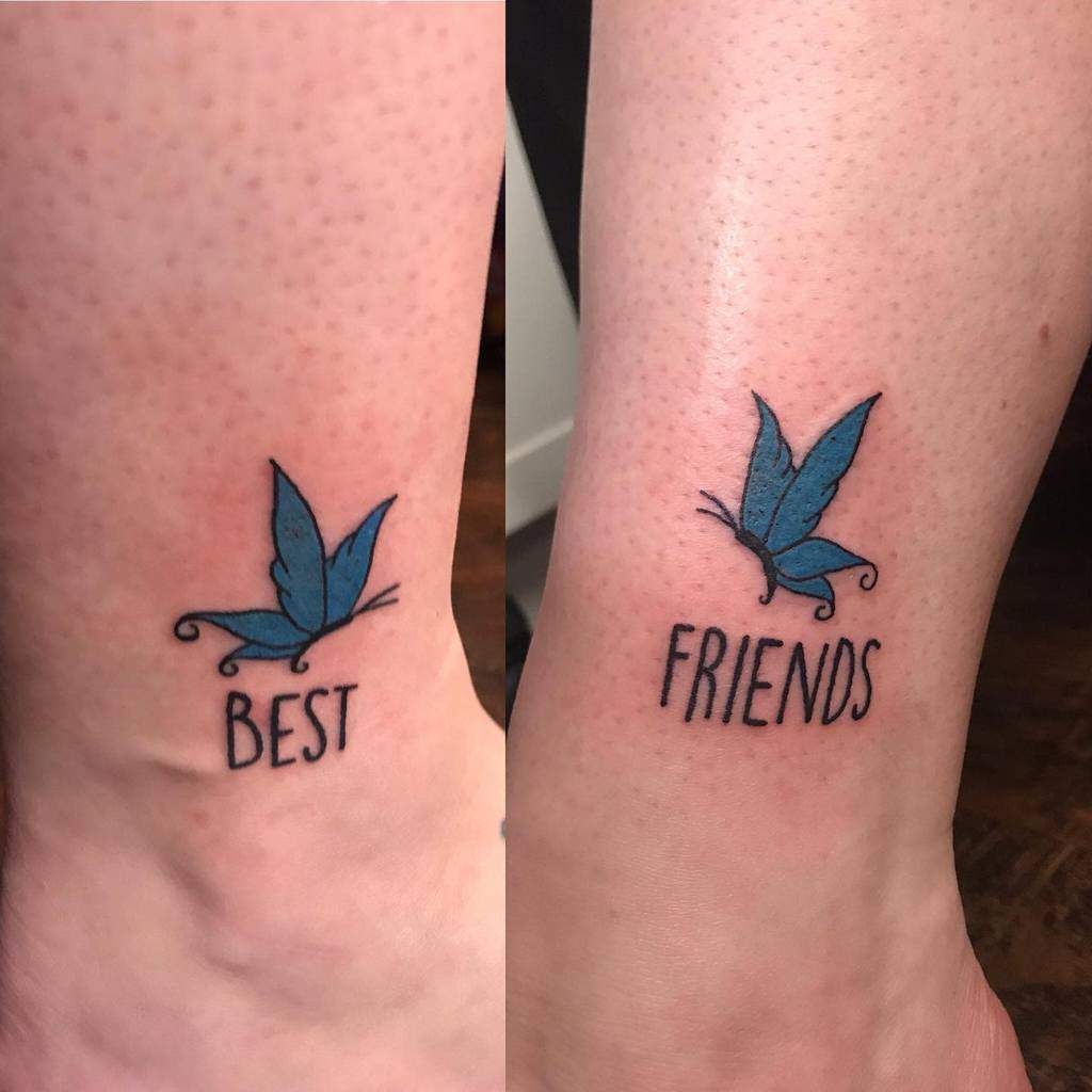 Two blue butterfly tattoos on ankles with the text "BEST FRIENDS" underneath