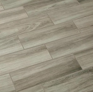 Light brown wood-look porcelain tiles with a matte finish and a natural grain pattern.