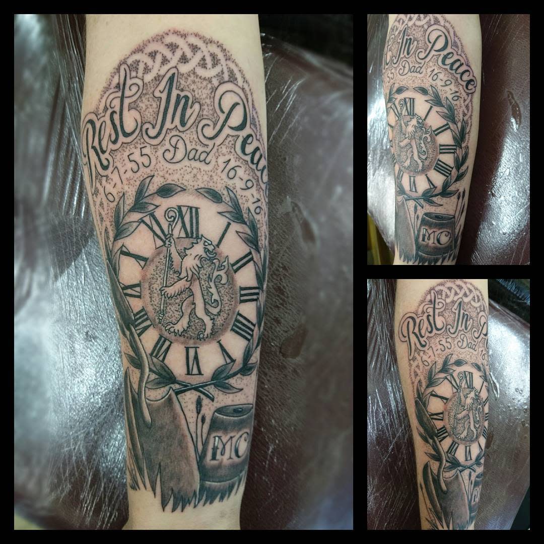 A detailed "Rest in Peace" tattoo featuring a clock, date, "Dad," an eagle, shield, and the "MC" symbol