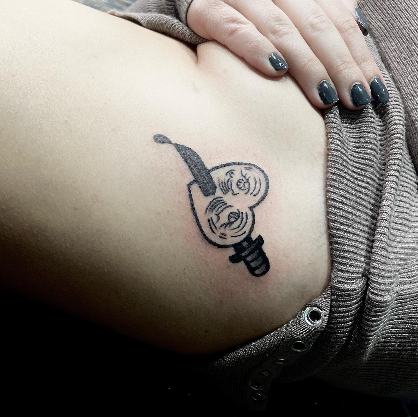 Tattoo of a crying heart stabbed by knife