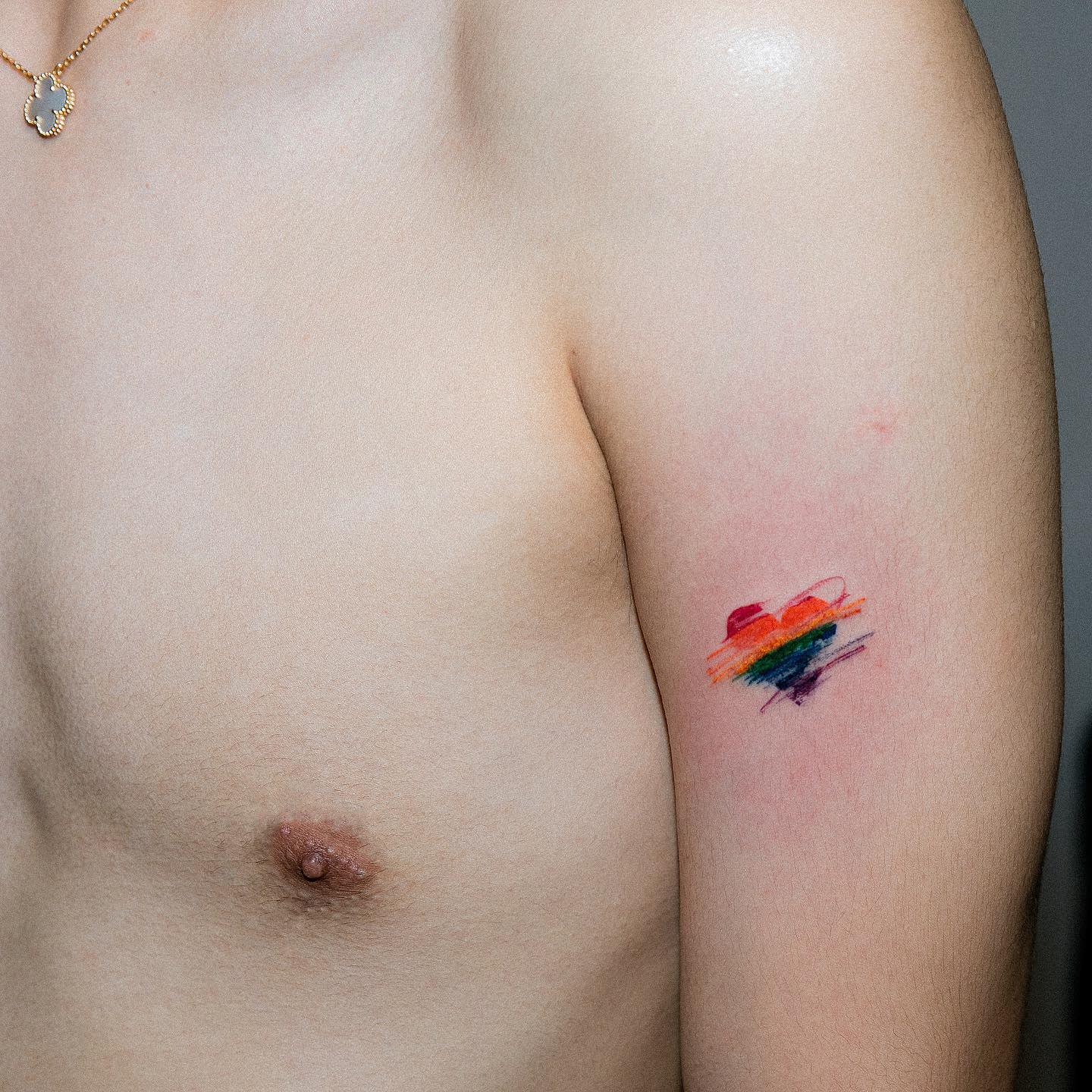 Close-up of an arm with a colorful rainbow tattoo