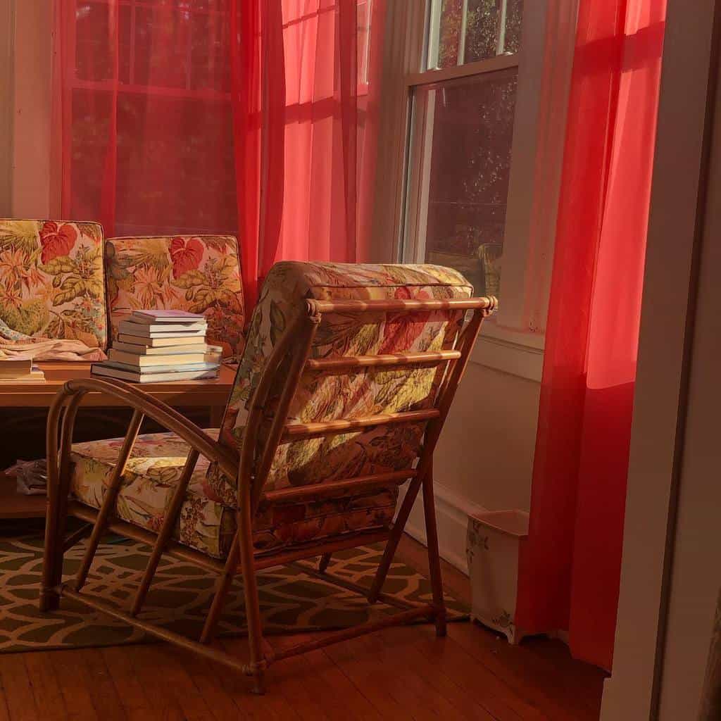 sunroom with red curtains and floral print seating