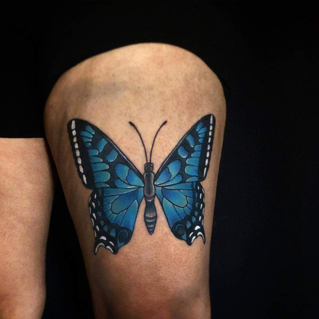 Tattoo of a blue butterfly with exquisitely detailed wings on an upper thigh