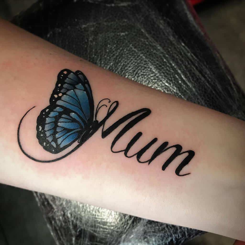Tattoo of the word "Mum" adorned with a delicate blue butterfly on an arm