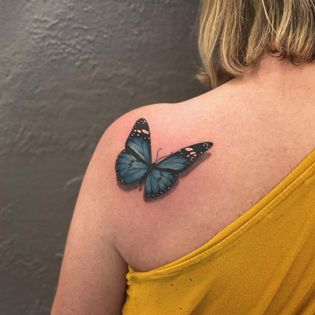 A delicate blue butterfly tattoo adorns the woman's shoulder