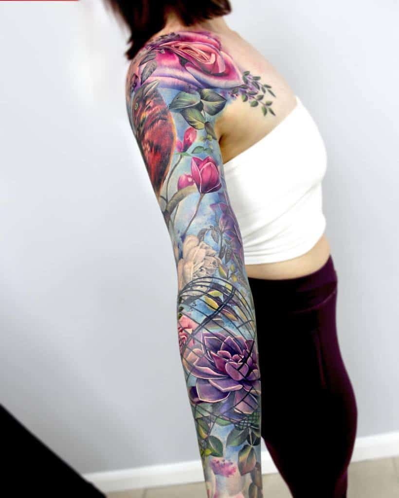 A woman flaunts a vibrant floral sleeve tattoo