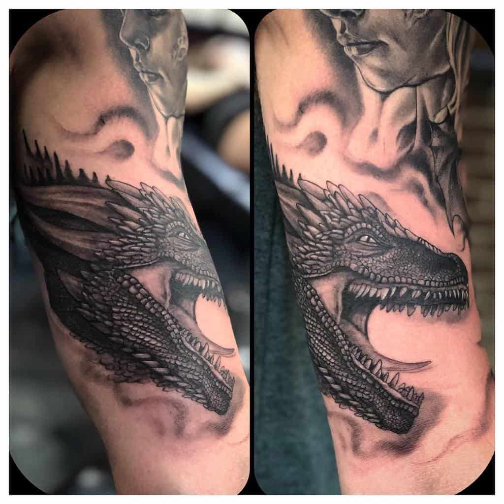Detailed forearm tattoo showcasing a close-up of a dragon’s face, capturing fierce scales and intense gaze