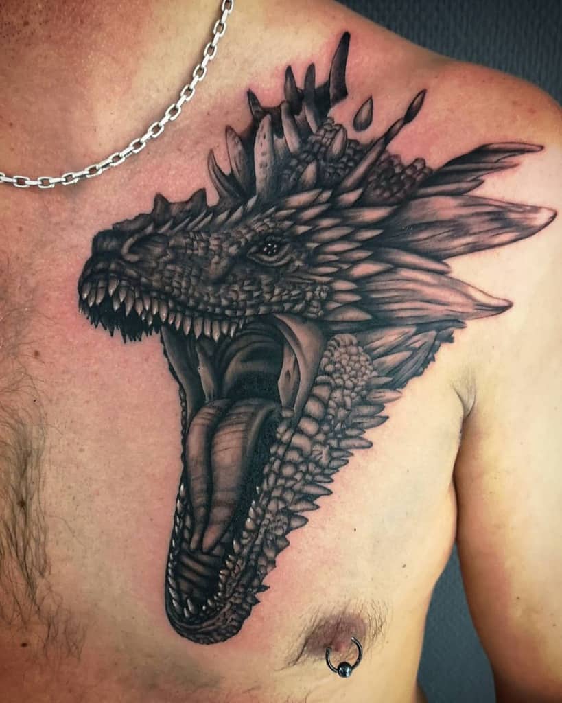 Chest tattoo of a roaring dragon with detailed scales and an open mouth