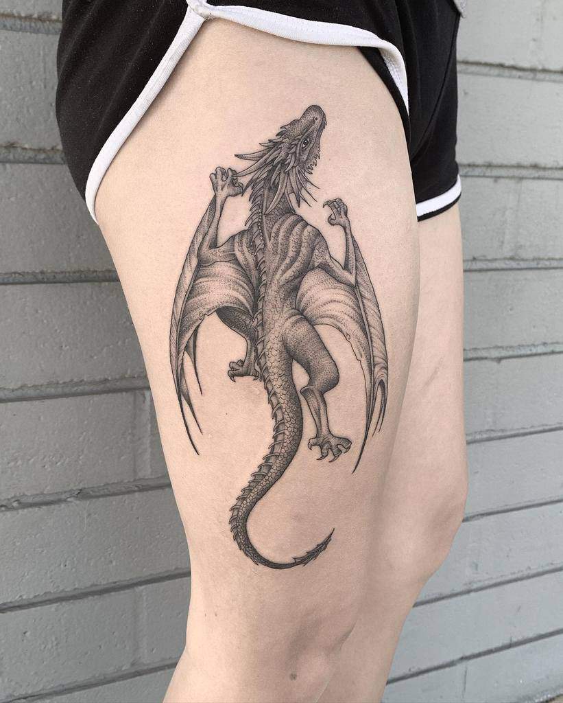 Detailed dragon tattoo on a person's upper thigh