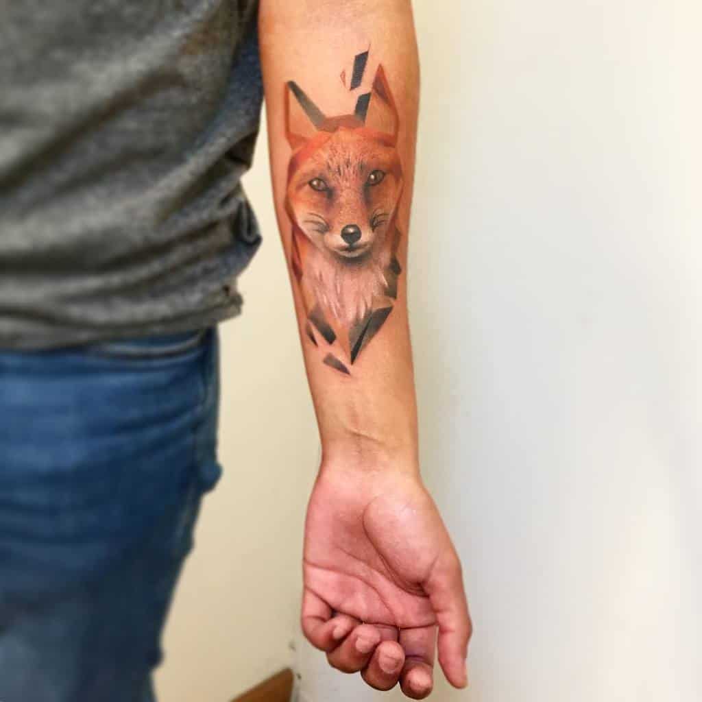 Forearm tattoo of a detailed geometric fox face