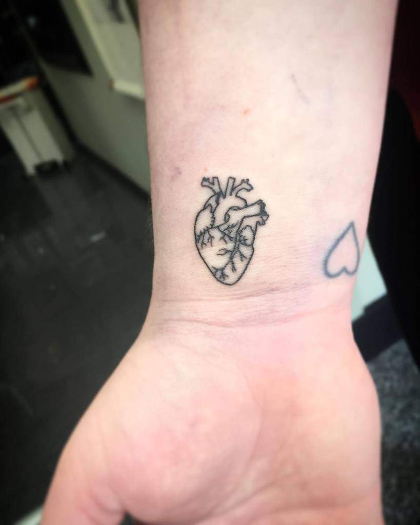 Small anatomical heart tattoo on wrist