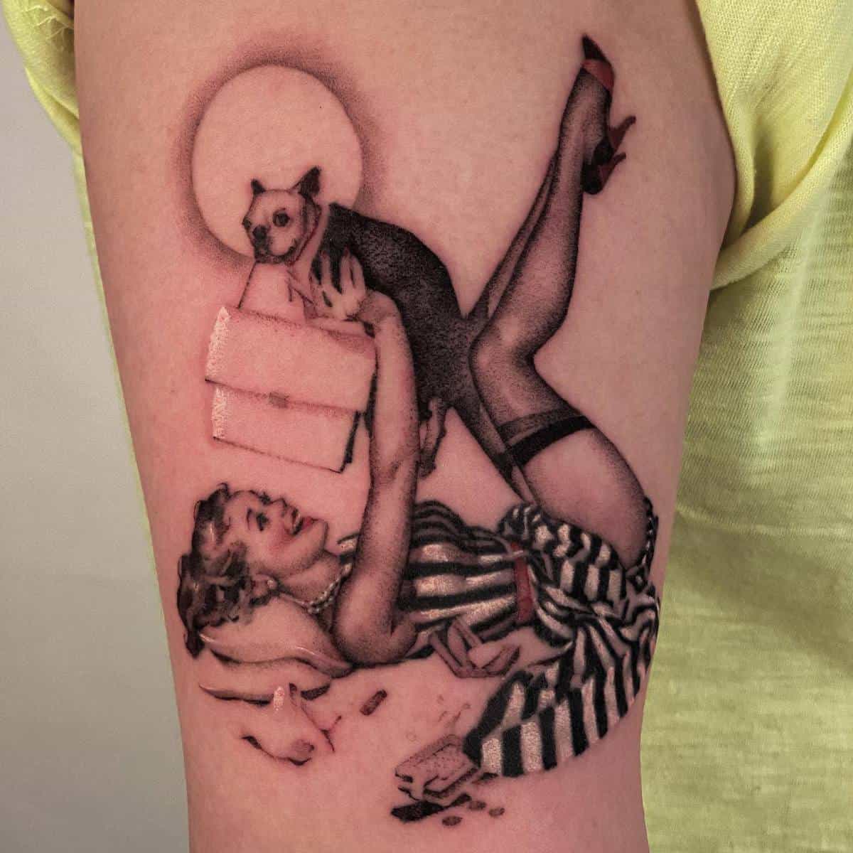 Tattoo of a pin-up girl reading beneath a full moon with a small dog perched on her raised leg wearing striped stockings