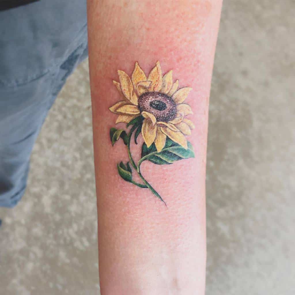 A realistic sunflower tattoo on a forearm 