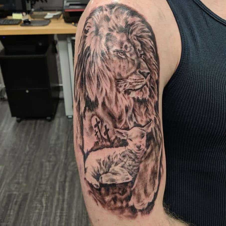Tattoo of a lion and lamb on an upper arm, both surrounded by intricate shading and delicate details