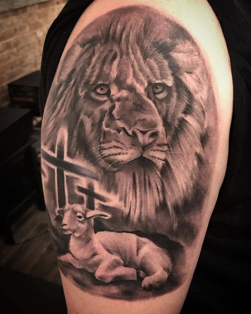 A striking tattoo on the upper arm features a majestic lion and a gentle lamb, both framed by crosses in the background