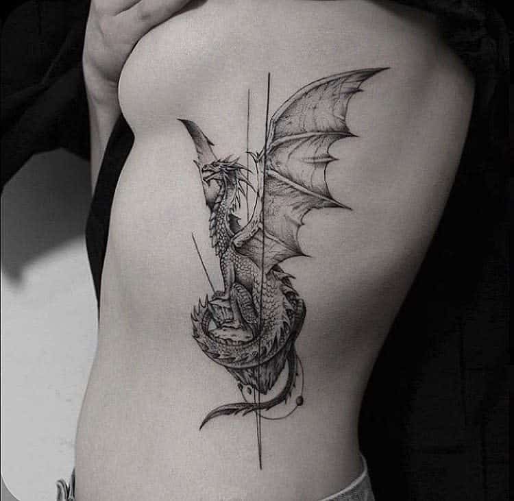 Black and white tattoo of a dragon on a woman's ribcage