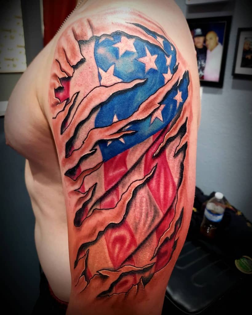 Arm tattoo of torn skin revealing the American flag underneath