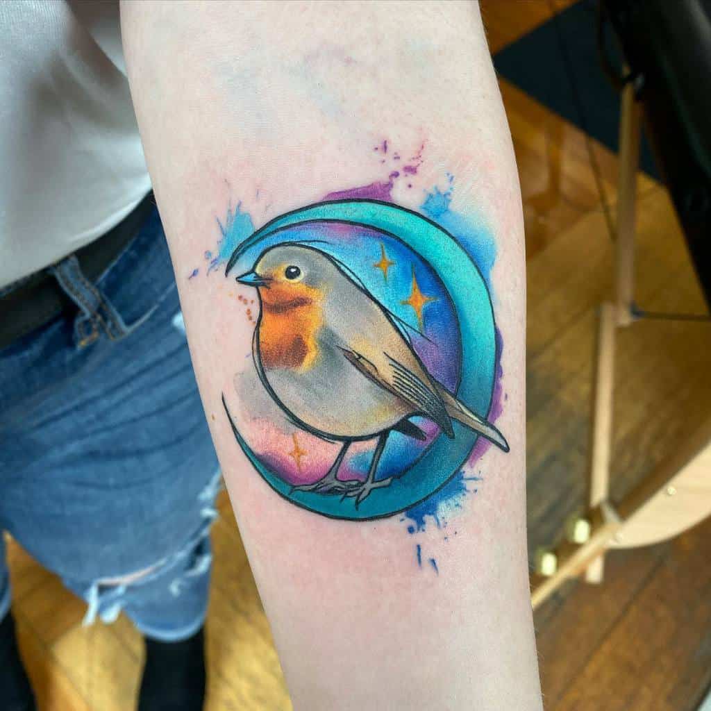 Tattoo of a small robin with orange chest inside a blue crescent moon with three yellow diamond stars, with colorful blue and violet splashes around it