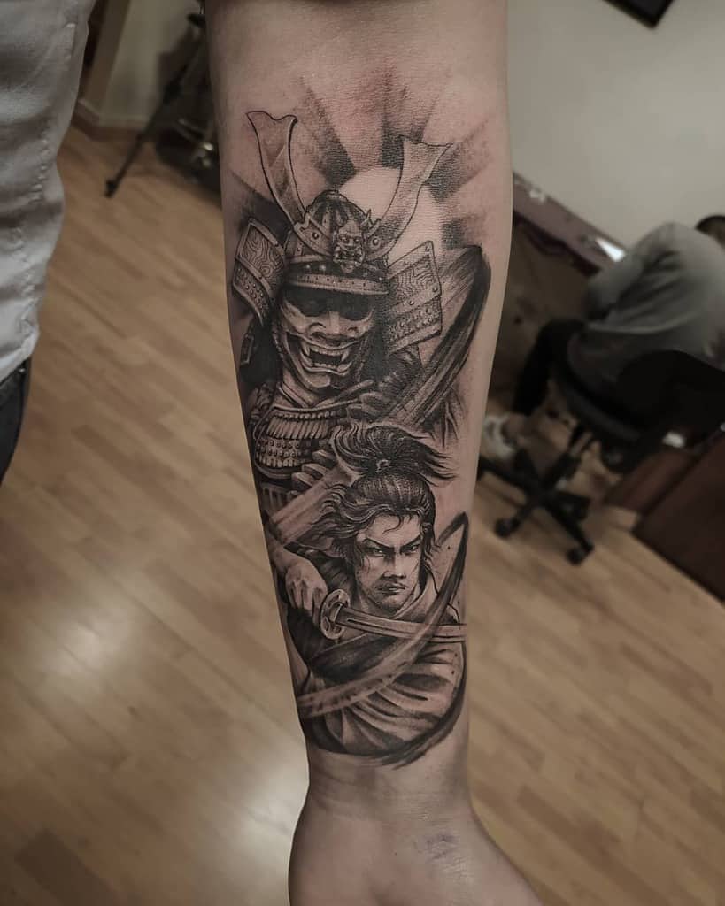 Detailed black and gray forearm tattoo of a Ronin wielding a katana, paired with a fierce samurai mask and radiant background highlights