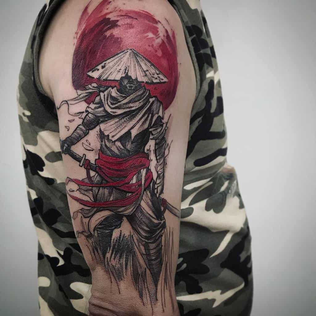 Dynamic upper arm tattoo of a Ronin with a straw hat, red sash, and bold red sun backdrop, creating a striking and vivid design