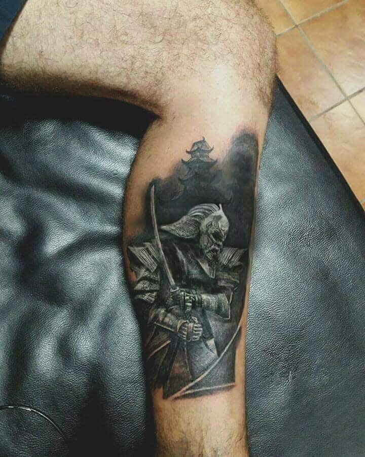 Black and grey leg tattoo showcasing a stoic samurai warrior holding a katana, with a distant Japanese castle in the background, emphasizing a traditional and mysterious aesthetic.