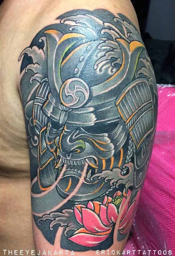 Dynamic samurai tattoo with waves, a fierce warrior mask, intricate armor, and a vibrant pink lotus flower, showcasing bold color contrasts