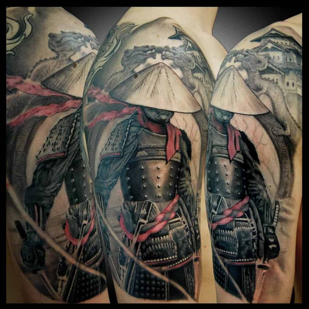 A detailed tattoo of a samurai wearing a traditional hat, with a flowing red scarf and intricate armor, set against a dramatic backdrop of clouds and architecture