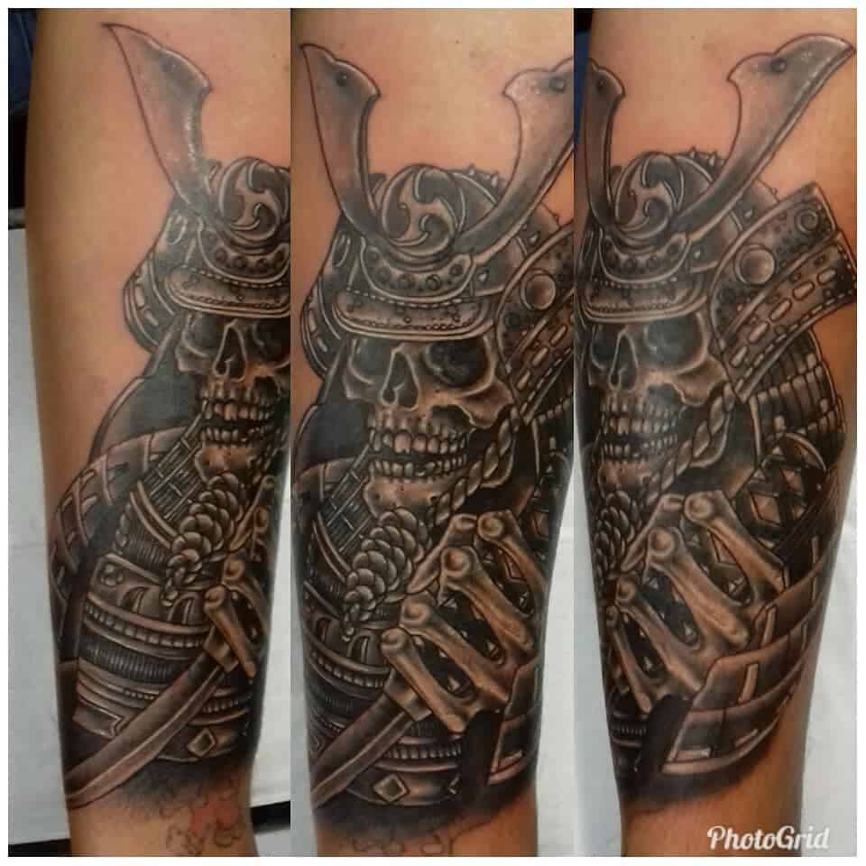 A detailed samurai skull tattoo with intricate armor and a sword, creating a fierce and powerful warrior look