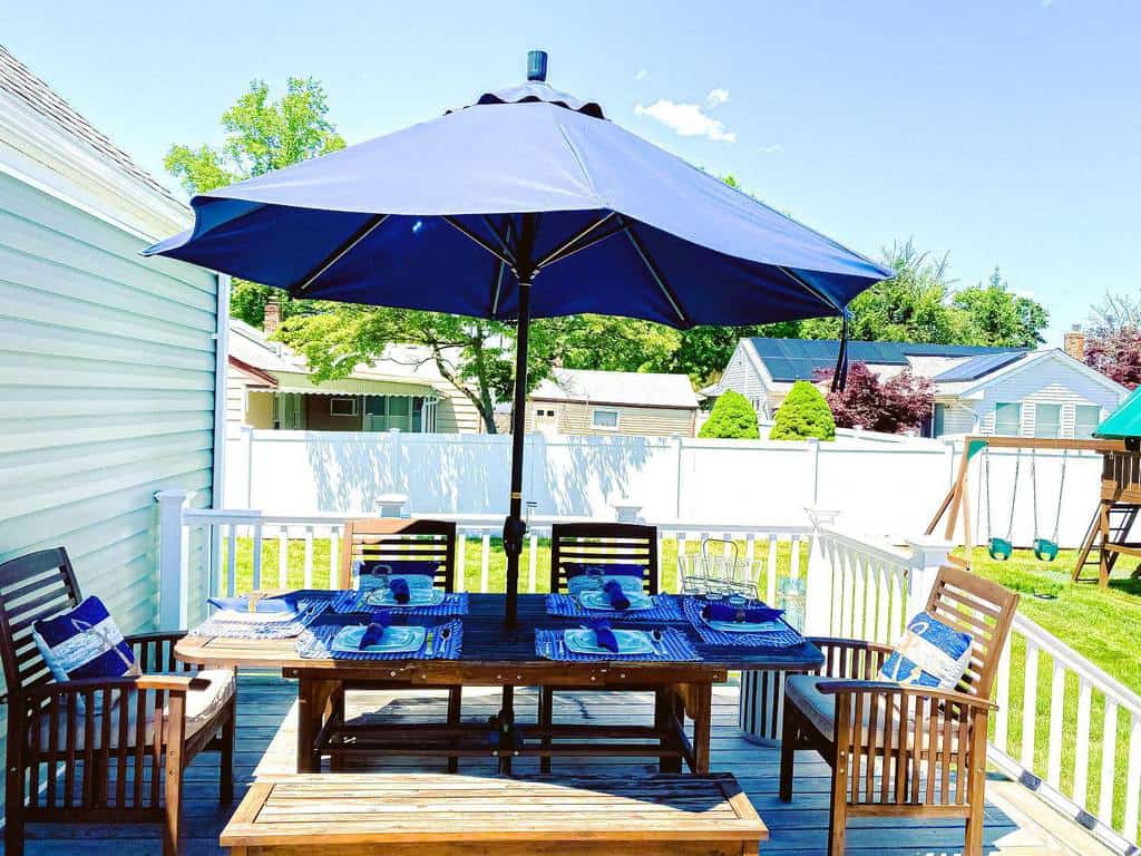 modern deck blue umbrella wood dining table