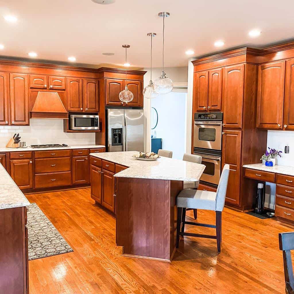 large stained wood cabinet kitchen dual overns island with polished granite countertop