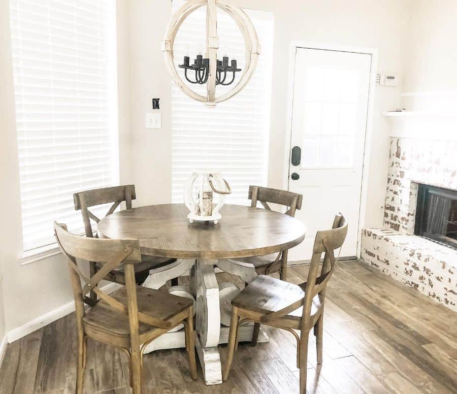 rustic dining room brick fireplace pendant ceiling light circular table with chairs 