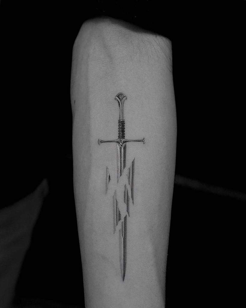 Forearm tattoo of a sword with geometric shapes intersecting its blade rendered in intricate single needle technique