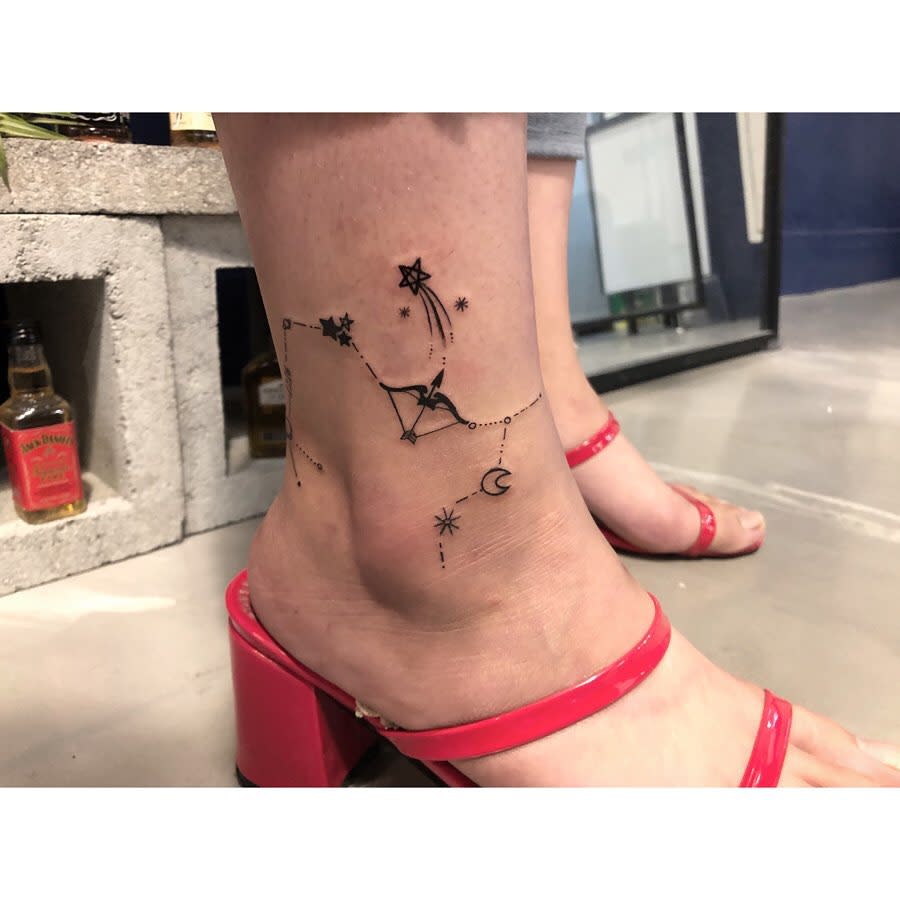 Ankle tattoo featuring stars, a Sagittarius constellation, and a moon