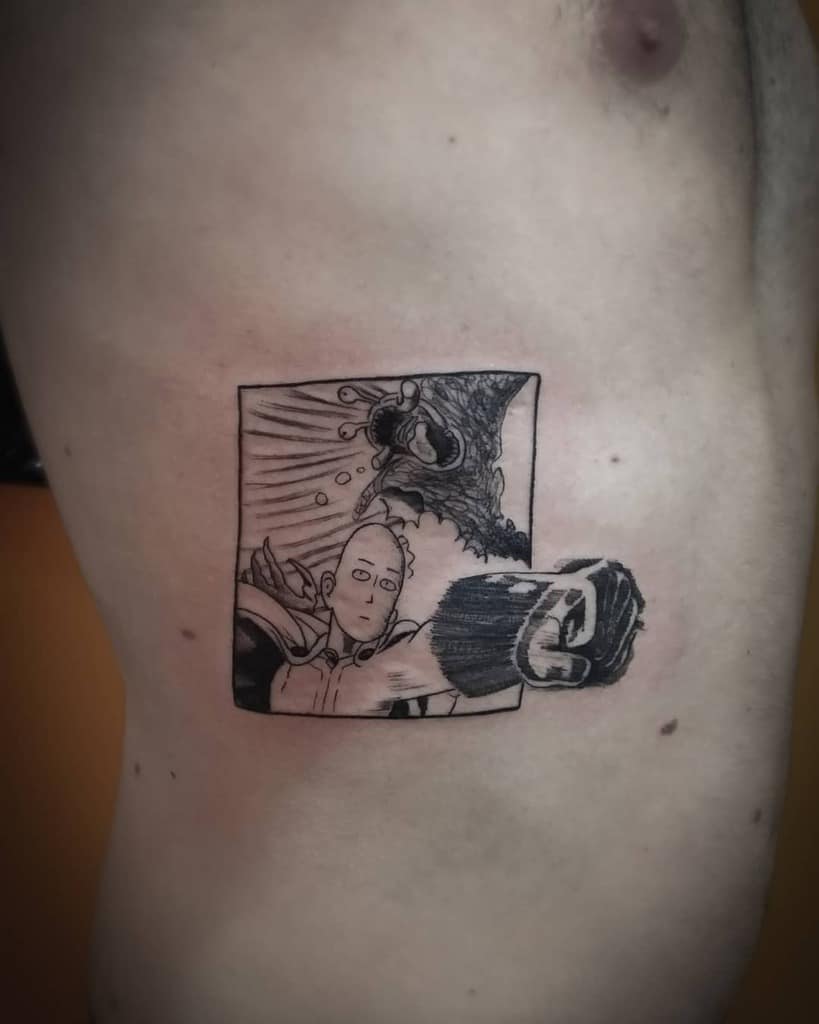 A black ink manga-style tattoo of Saitama from One Punch Man delivering a punch with a blank expression, framed within a comic panel