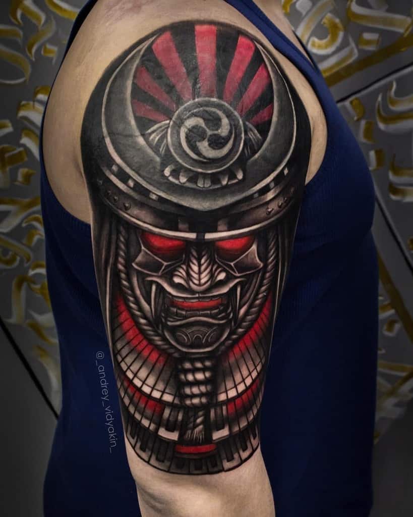 Bold samurai mask tattoo with glowing red eyes, black-and-red armor details, and a radiant sunburst pattern on the helmet