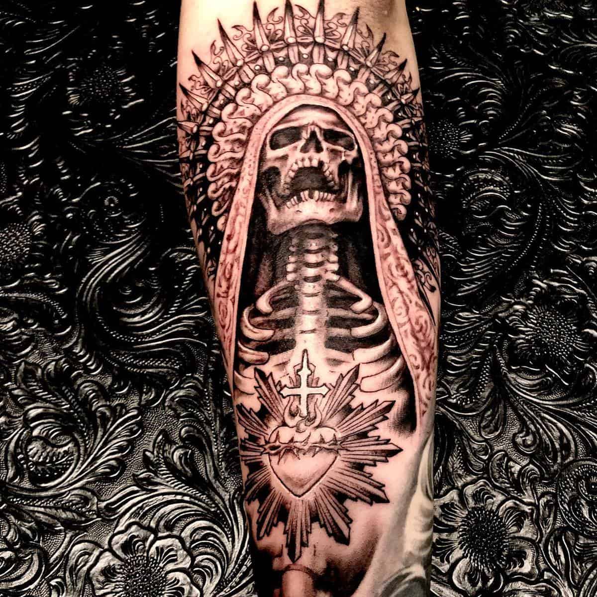 Santa Muerte tattoo featuring a skeleton with a radiant crown, intricate robe details, and a sacred heart