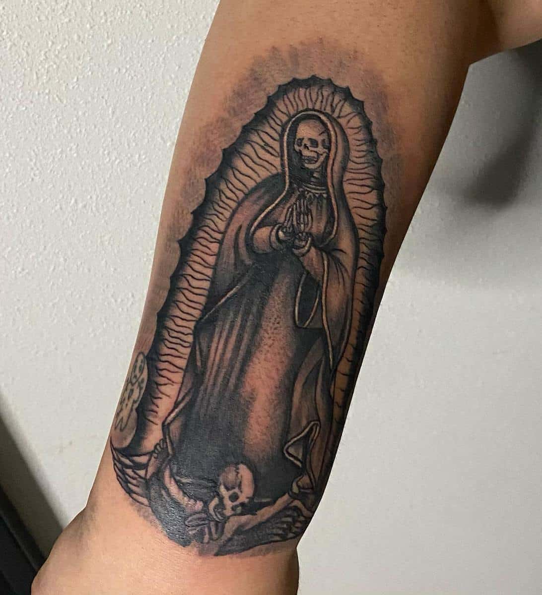 Santa Muerte tattoo with dark shading and skeletal imagery, symbolizing protection and life's fragility