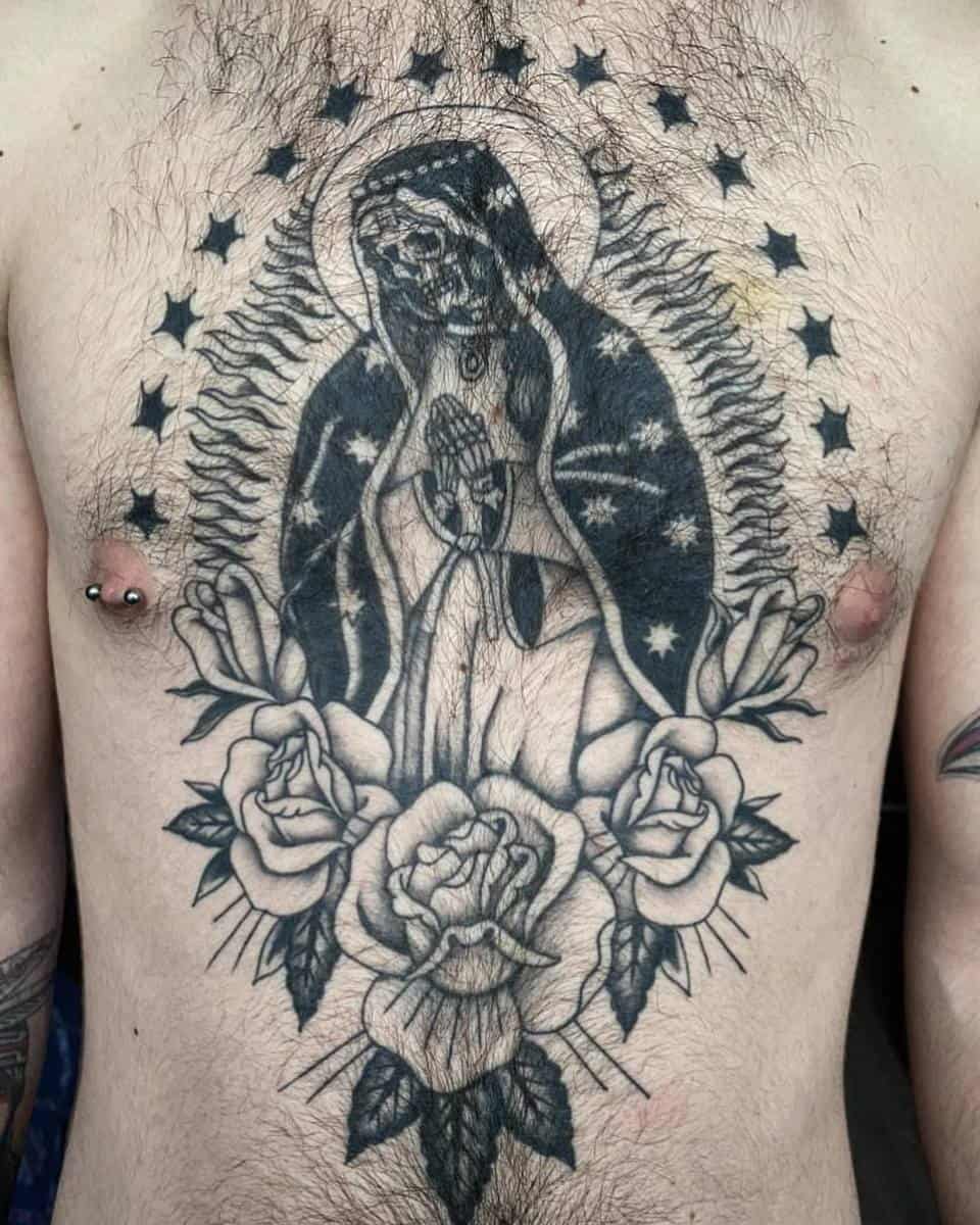 Santa Muerte chest tattoo featuring a skeleton saint surrounded by roses and stars, symbolizing devotion