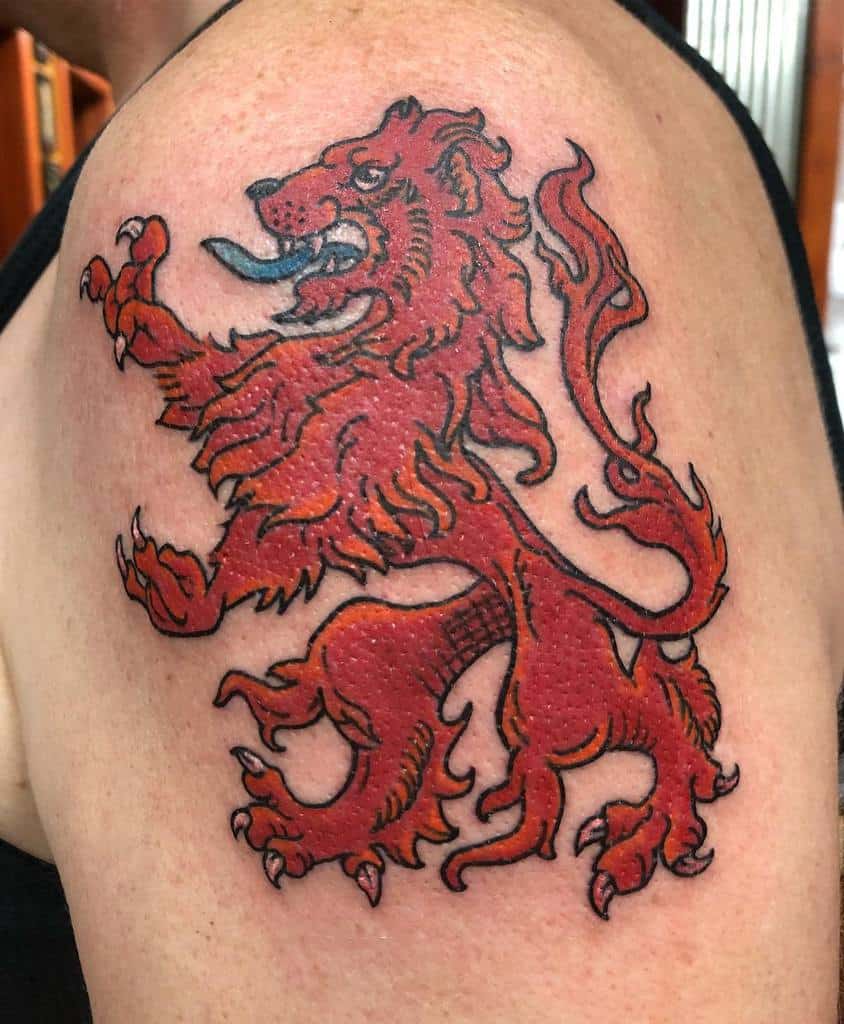 Tattoo of a red Scottish lion, with a touch of orange and a black lining in a heraldic pose, with detailed mane and tail