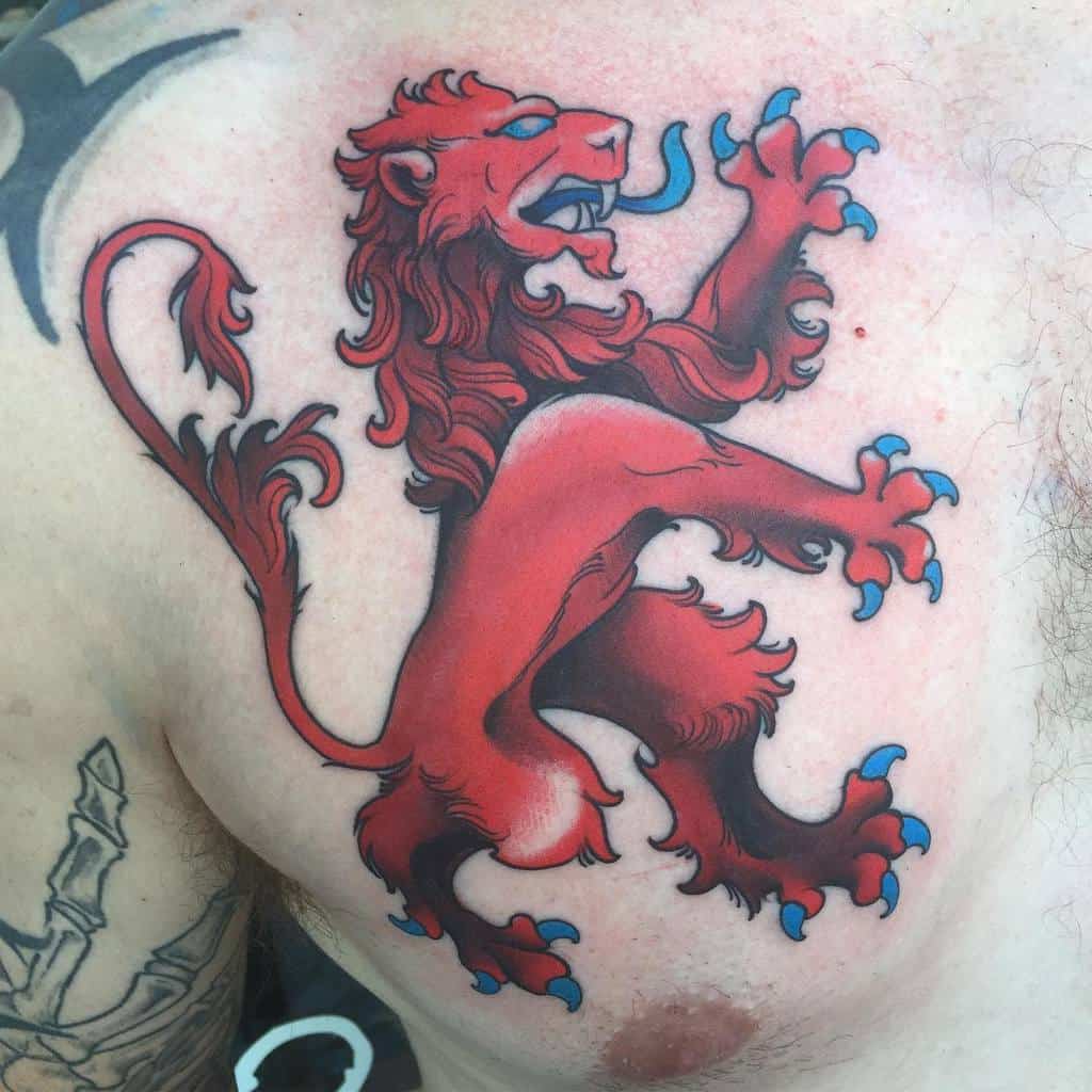 Bold red heraldic Scottish lion tattoo on the chest, featuring blue claws and tongue, with dynamic shading and fierce expression