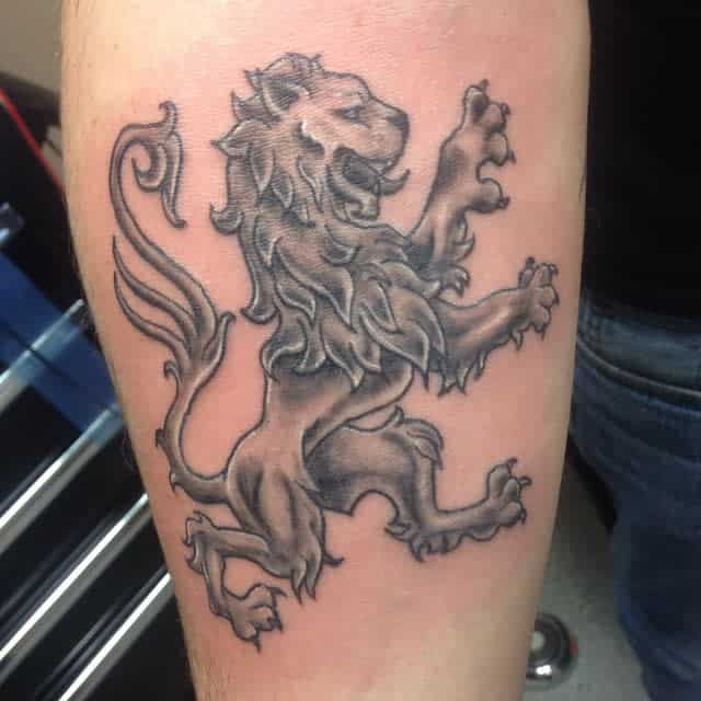 Tattoo of a Scottish lion in a heraldic style, depicted in a rearing position with flowing mane
