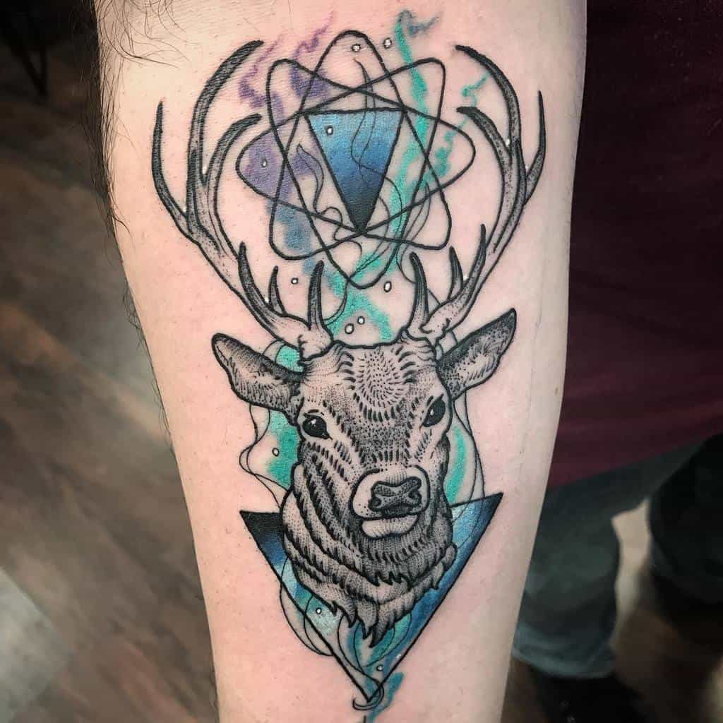 A Scottish stag tattoo with geometric triangle, and atomic structure above its head, with violet, blue and green watercolor splashes