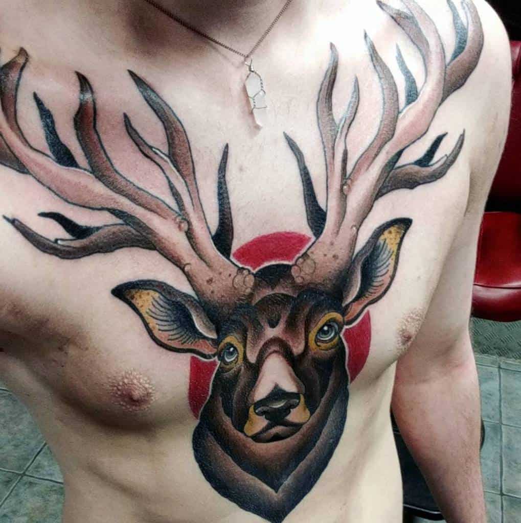 A large, detailed tattoo of a Scottish stag with prominent antlers and a red circle as a background