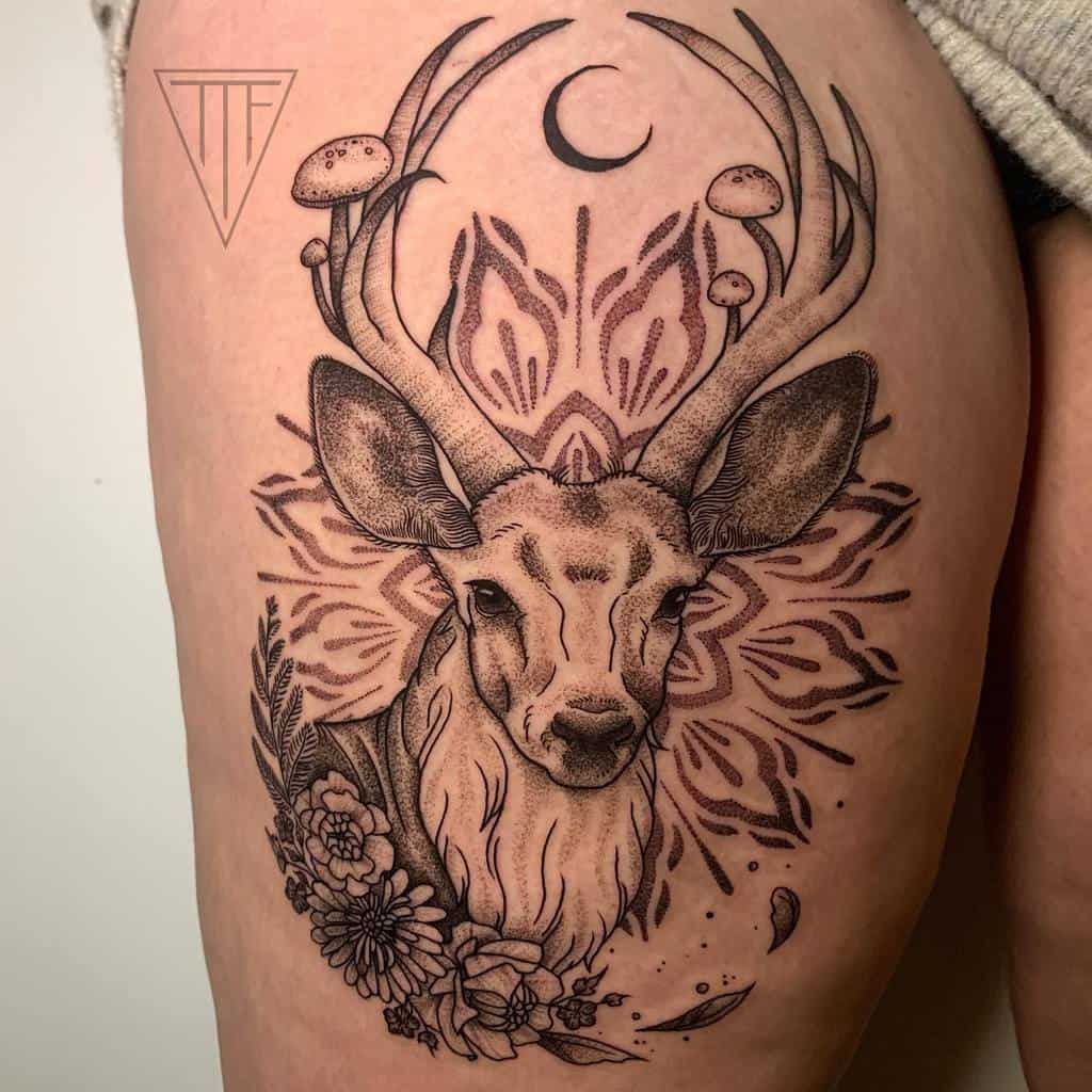 A Scottish stag tattoo with mushrooms in antlers, crescent moon above, decorative patterns, and flowers