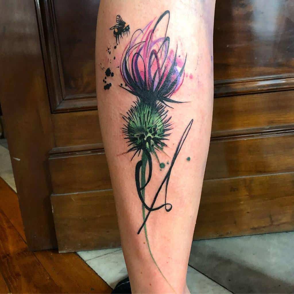A watercolor-style tattoo of a Scottish thistle with a pink flower and a small bee
