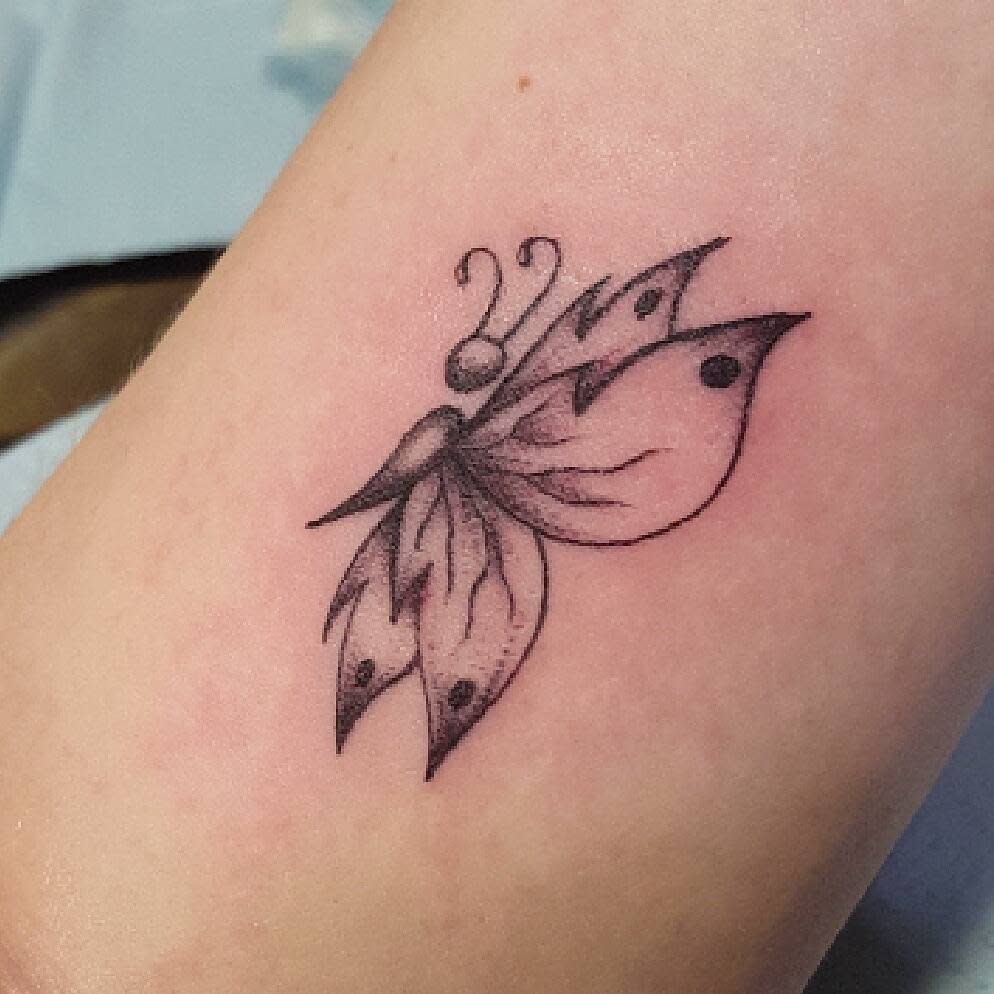 A delicate semicolon butterfly tattoo in black and white with soft shading, symbolizing transformation, mental health awareness, and inner strength, presented with a graceful, minimalist design