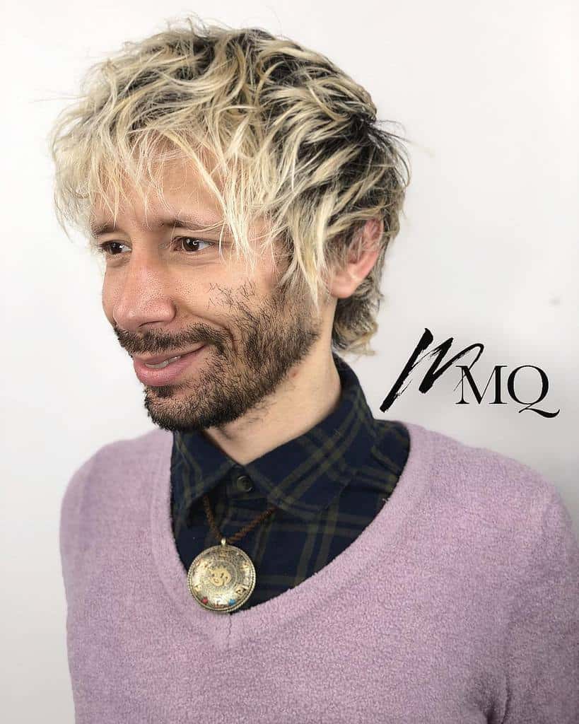 Shaggy Blond Hairstyle With Mid Length Locks. It Is A Great Look If You Want To Highlight The Angular Features Of Your Face